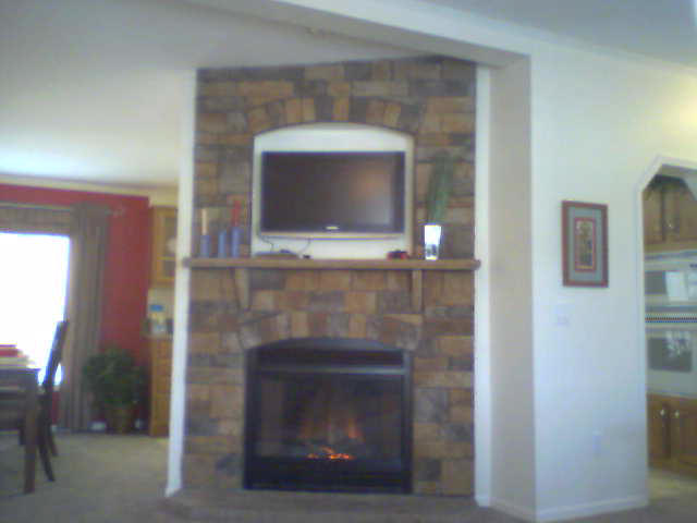 MESQUITE STONE AND TV SURROUND WITH STONE MANTEL